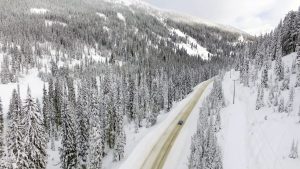 EV traveling snowy mountain road